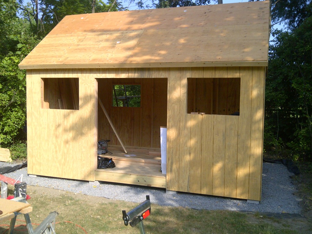 New wooden shed under construction in a yard