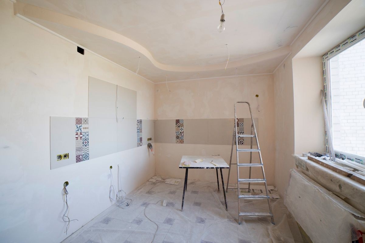 Room in the middle of a renovation with a ladder and tools